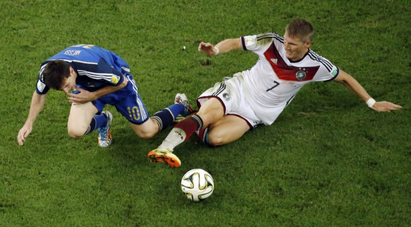 Bastian Schweinsteiger tackling Lionel Messi