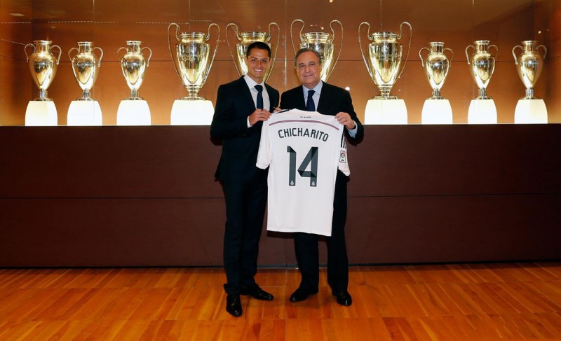 Javier Hernandez Chicharito holding his news Real Madrid jersey number 14
