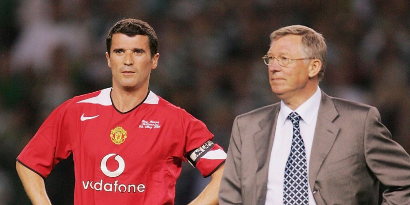 Roy Keane standing next to Sir Alex Ferguson, in Manchester United in 2004