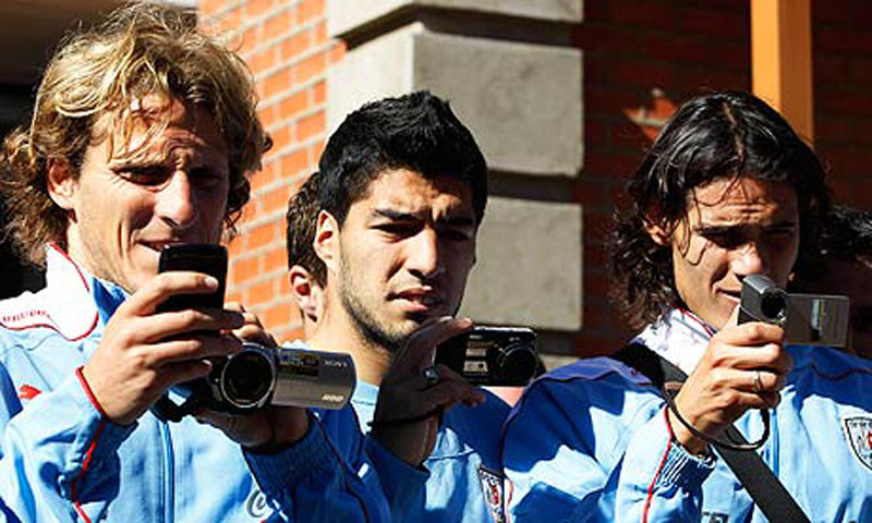 Diego Forlan, Luis Suarez and Edinson Cavani taking photos