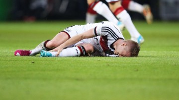 Marco Reus holding his left ankle, after injury ahead of the World Cup