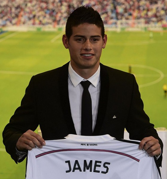 James Rodríguez holding his new Real Madrid jersey