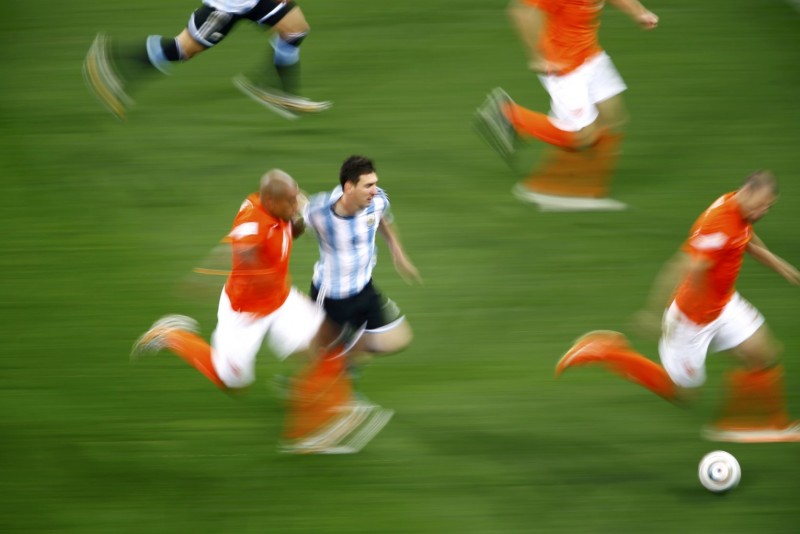 Lionel Messi racing past De Jong, in Argentina vs Netherlands, at the 2014 FIFA World Cup