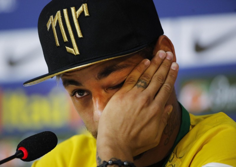Neymar wiping the tears of his face after crying