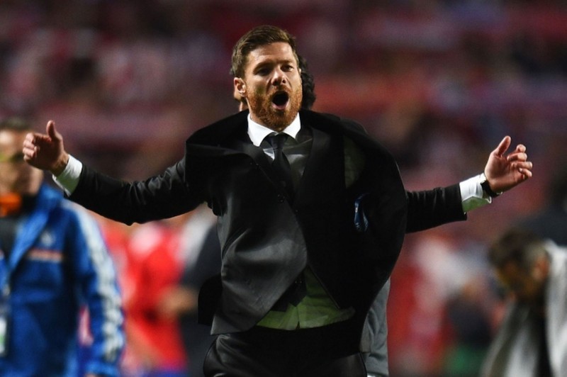 Xabi Alonso suited up, celebrating Real Madrid goal in the Champions League final