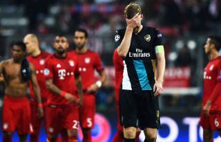 Mertesacker covers his face in shame, after Arsenal got humiliated against Bayern Munich