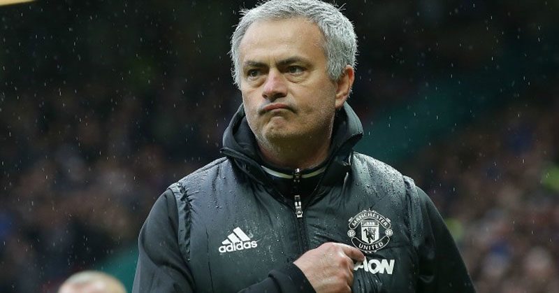 José Mourinho points to Manchester United badge