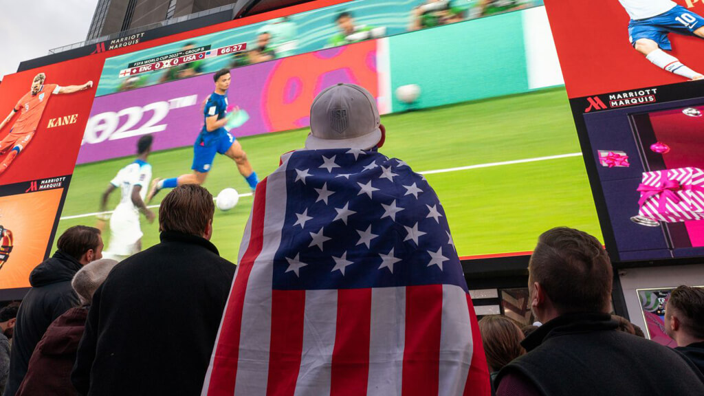 Fans watching soccer in a big tv screen in the USA